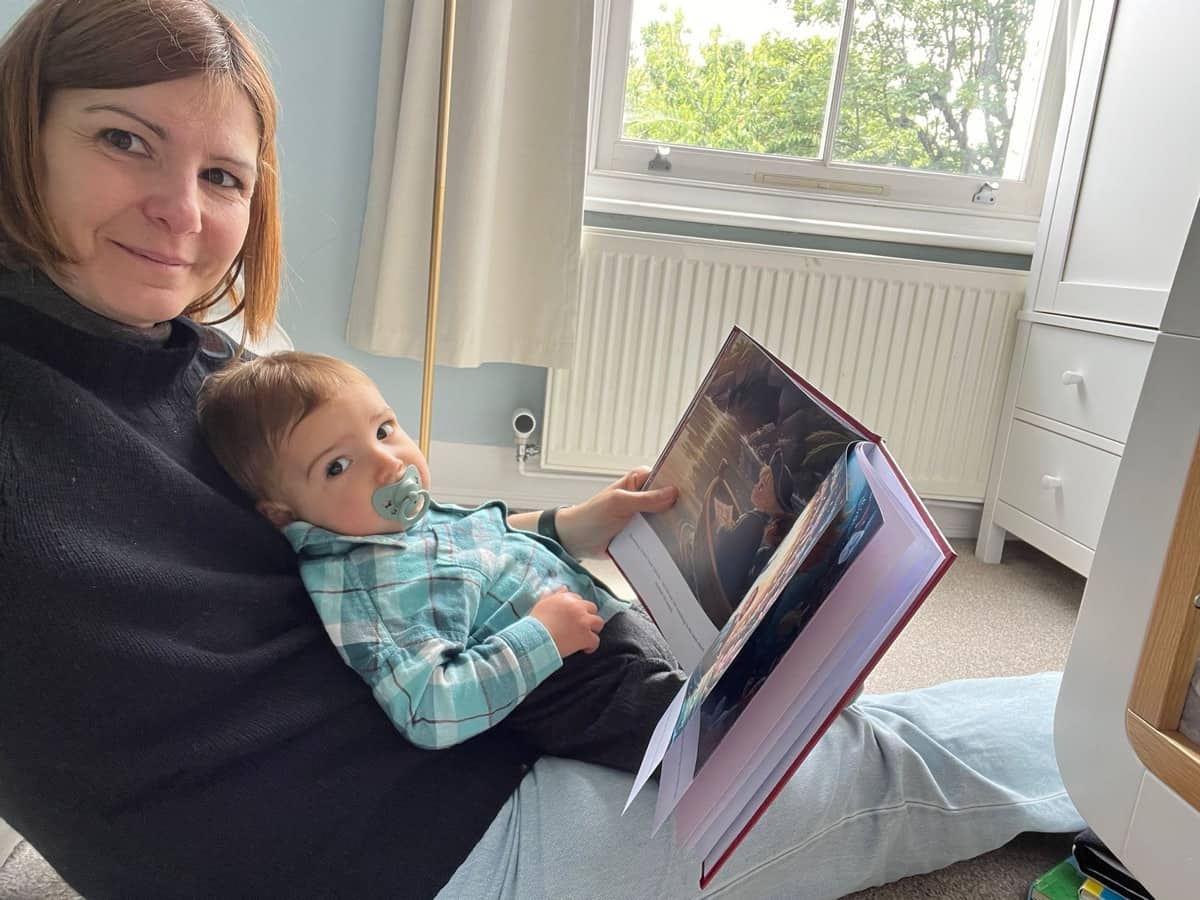 Federica reading the personalized LegendCraft book with baby Edoardo