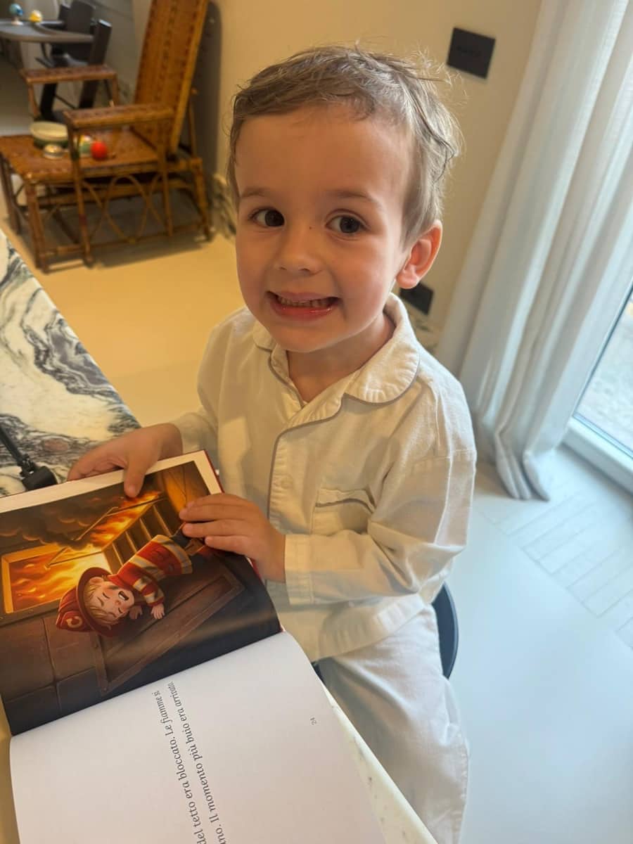Alberto smiling while holding his personalized LegendCraft book